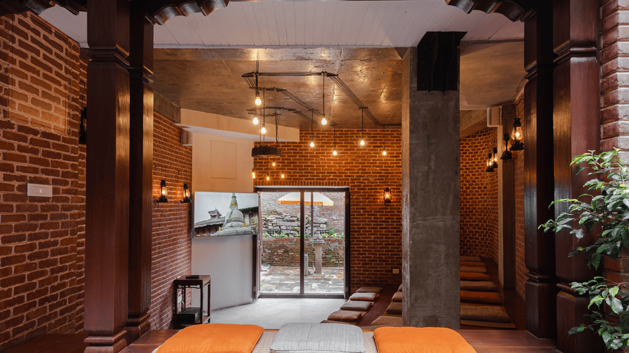 The elegant interior design and floor-seated lounge area of a heritage boutique hotel lobby in Bhaktapur, Nepal.