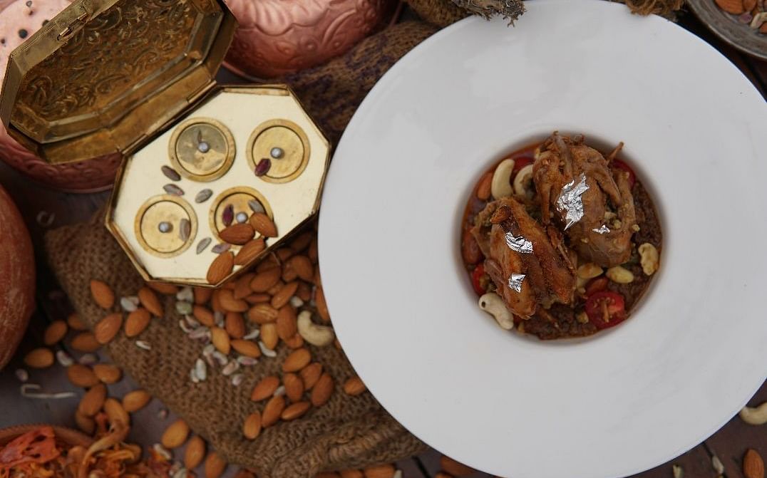 Top view of a dish placed on a table with dry fruits placed besides it