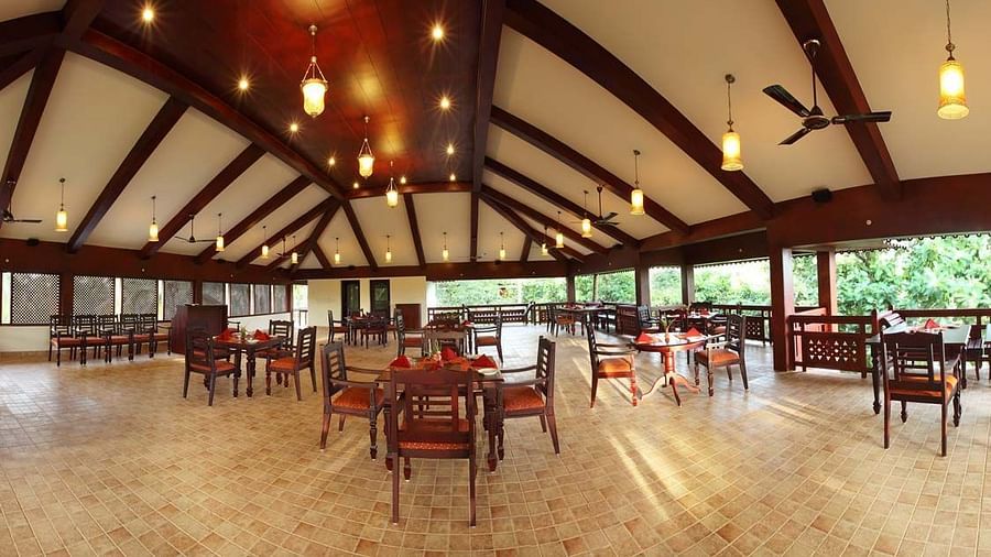 Dining area with tables laid with cutlery, prepared for the meal to be served