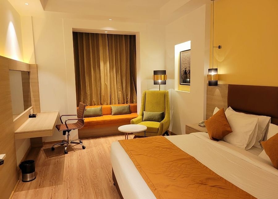alt-text room with a king size bed and wooden flooring at best western vrindavan