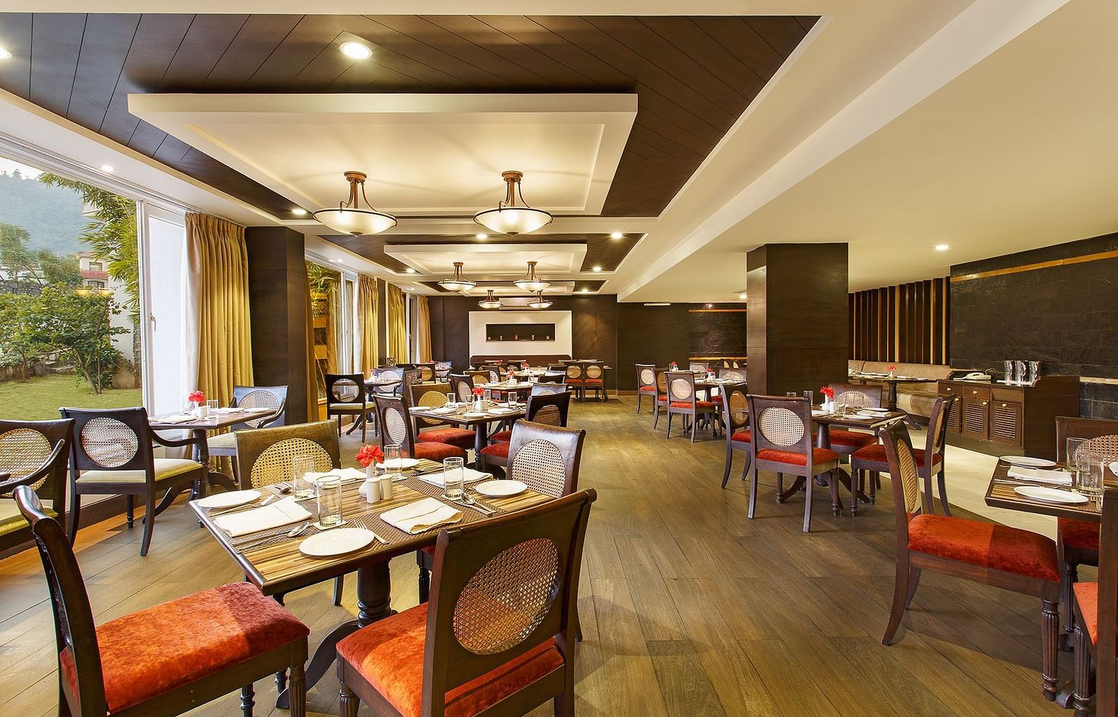 Latitude - A multi-cuisine restaurant in Rishikesh with tables and chairs in clusters spread across the space - Aloha On The Ganges, Rishikesh