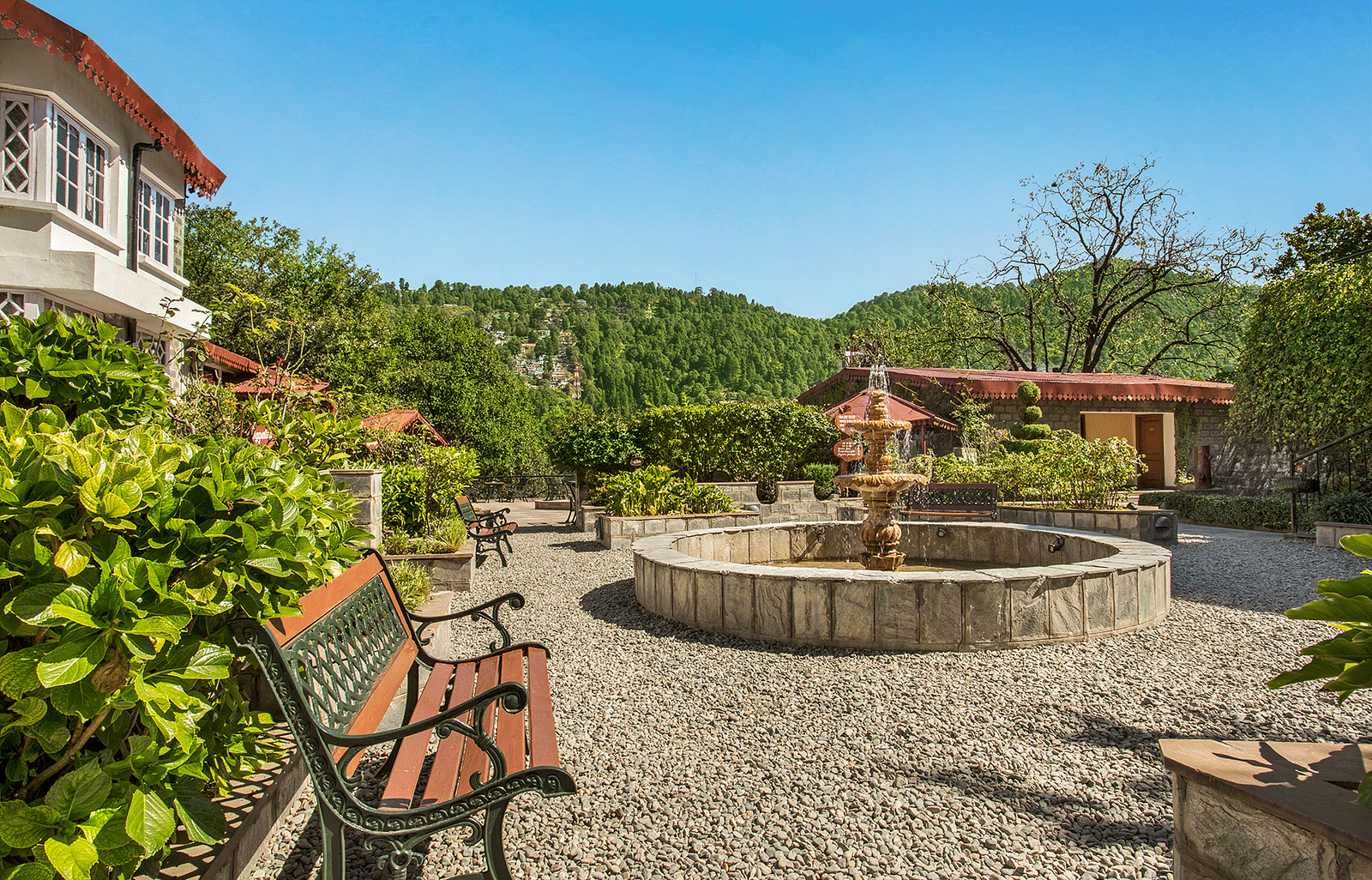Image featuring Garden Sit-Out Area at the naini retreat, nainital. A fountain in the middle and 