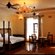 A room with a twin large bed, spreads, pillows, a fan, chairs, and a chandelier. | Hotel Devnadi, Haridwar
