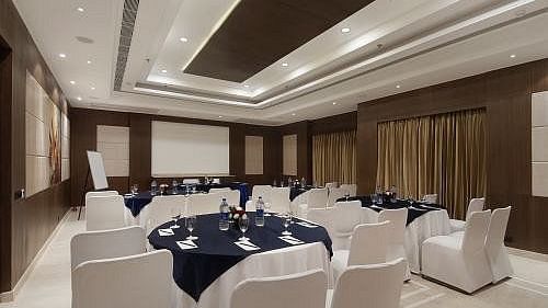 The Senate Banquet Hall with round tables and seating arranged aesthetically for the event at Inde Signature Tower, Gurgaon