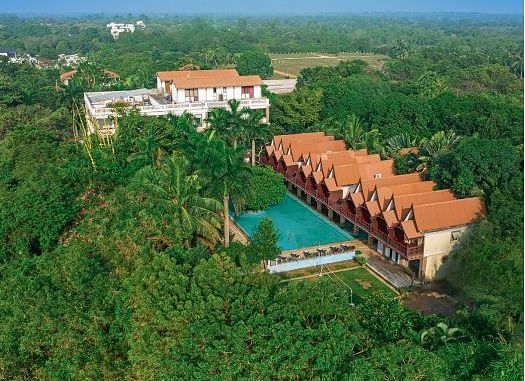 Facade of Mango Hill Resort, Pondicherry surrounded by trees 