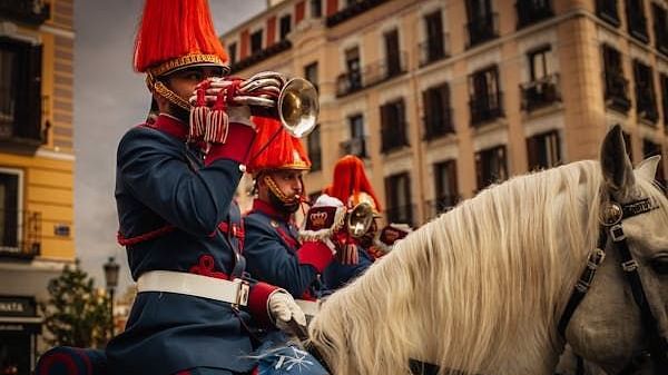 Several guards on horseback, riding in a line.