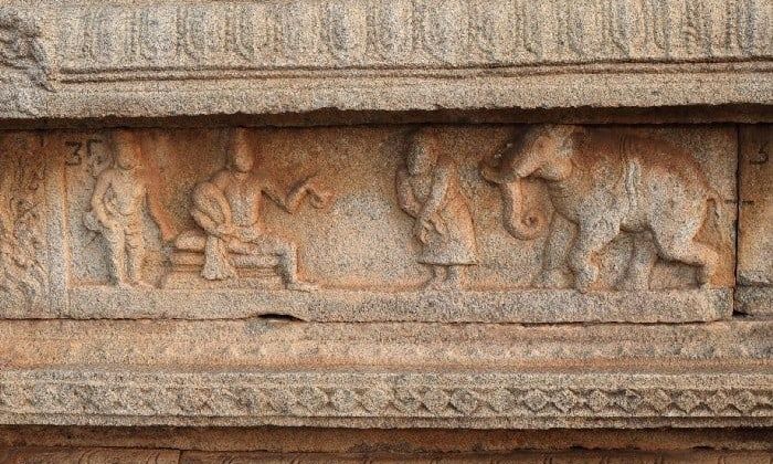 Hampi stone carving with figures and an elephant.