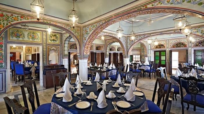 a restaurant with blue covers and tables and chairs  - Hotel Castle Mandawa, Jhunjunu
