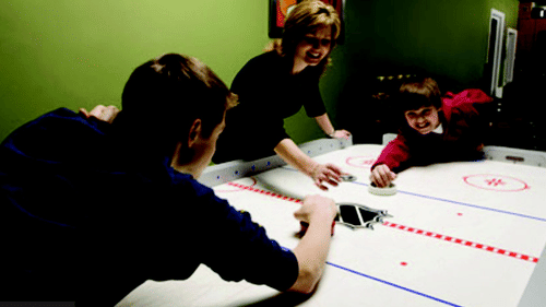 An air hockey table with two players at The Retreat Hotel and Convention Centre.