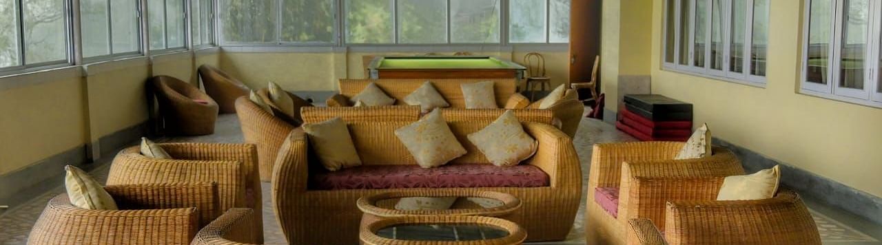An image of the lobby area with sofa set overlooking the valleys - Sumitel Chiminda, Pelling