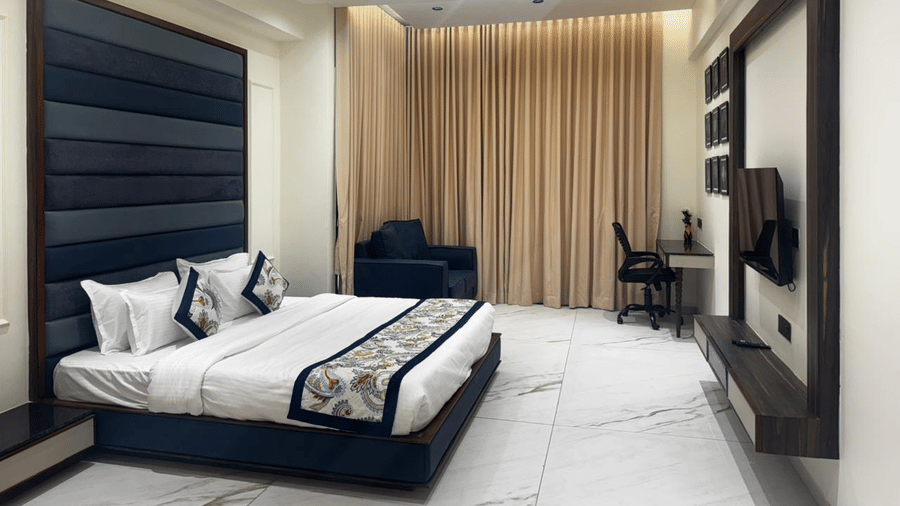 Guest room corner showing triple occupancy bedding and storage - Lords Swastik Studio, Kodinar