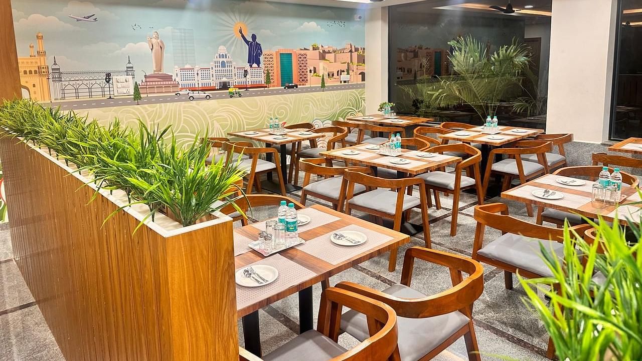 An image of a restaurant where many tables and chairs are arranged | Hotel Aerotel, Hyderabad