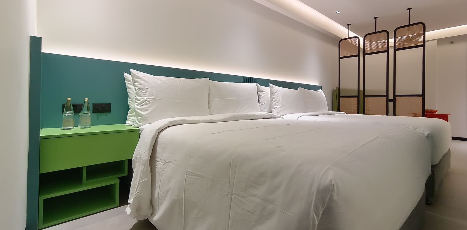 Vibrant bedroom with colourful interiors and a neatly made large bed