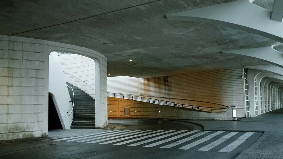 An image of a parking area showcasing a staircase, and zebra crossing