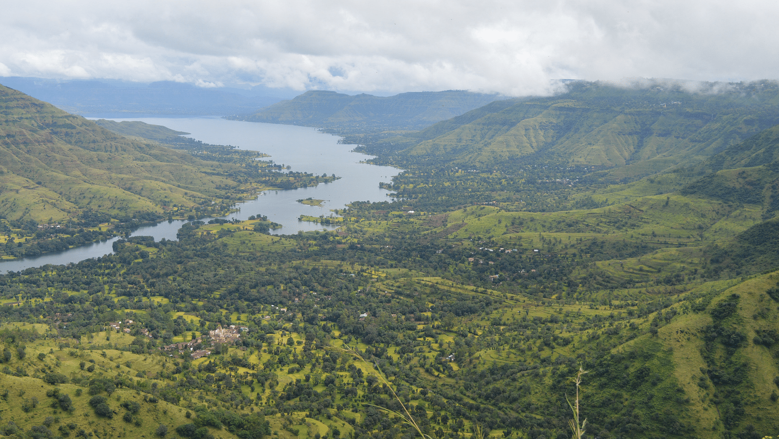a stream of river flowing between mountain ranges