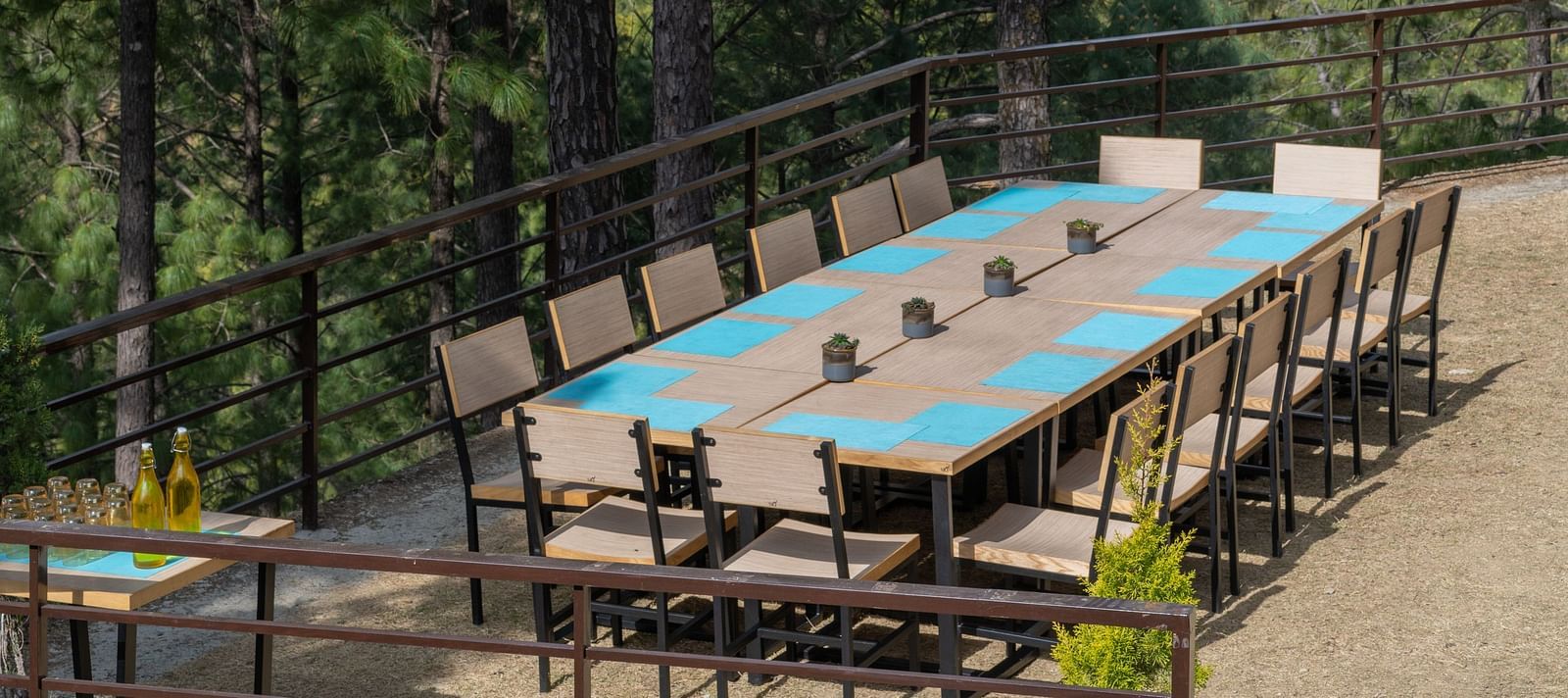 Lawn with neatly arranged chairs and a long table set up for an event at BluSalzz Escapade Resort, Lansdowne