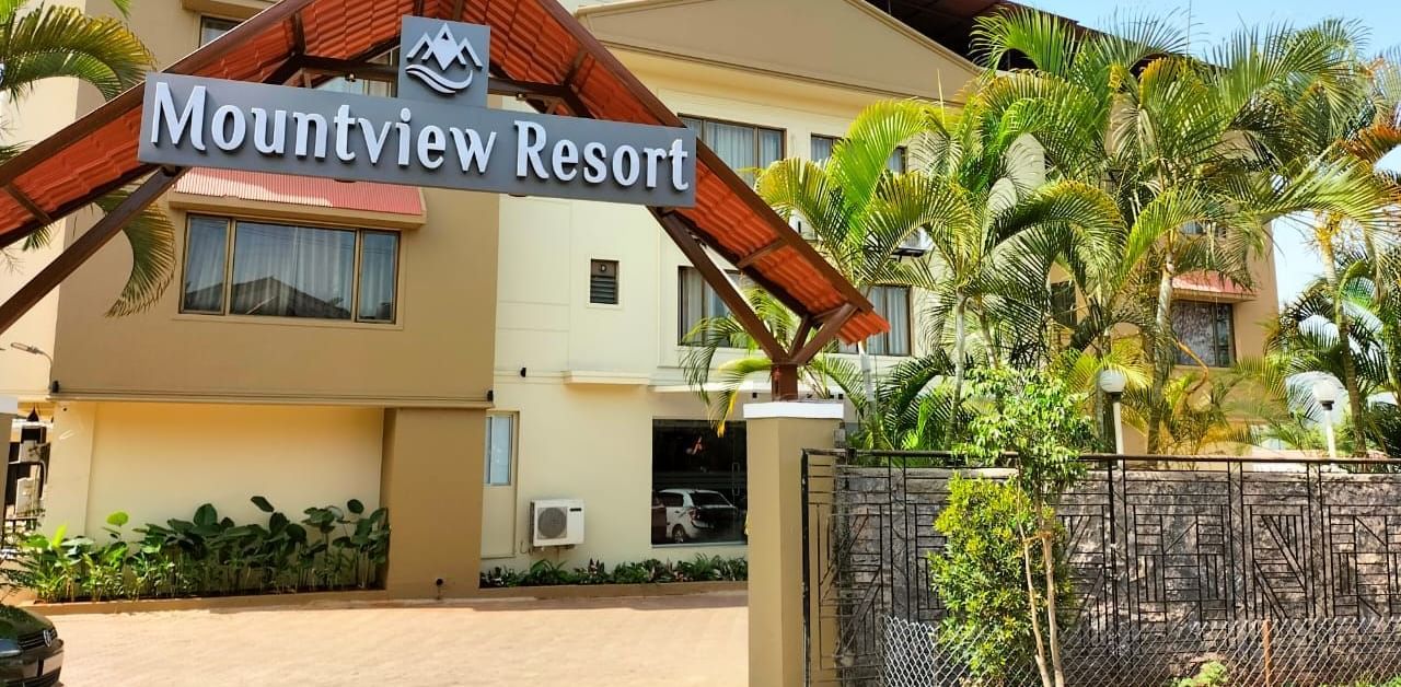 Mountview Resort entrance in Lonavala featuring lush greenery, spacious driveway, and clear resort signage for a welcoming first impression.