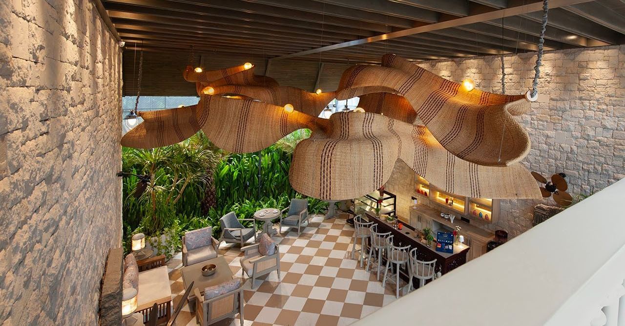 Full view of Suenos de Cafe taken from a higher level featuring an expansive dining area with ample of natural light falling over it.