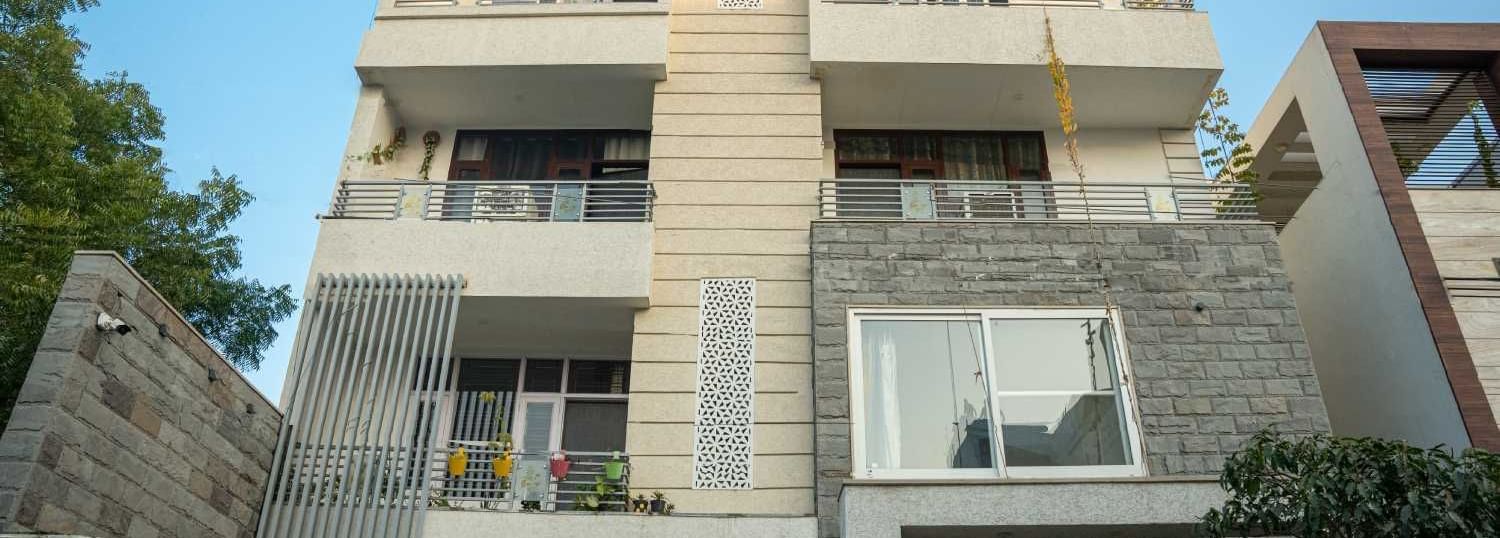 Exterior view of the modern multi-storey homestay building showcasing its contemporary design at Jaypore360 Homestay.