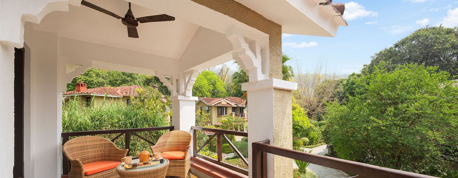 A balcony with a railing, overlooking a scenic view with trees or mountains.