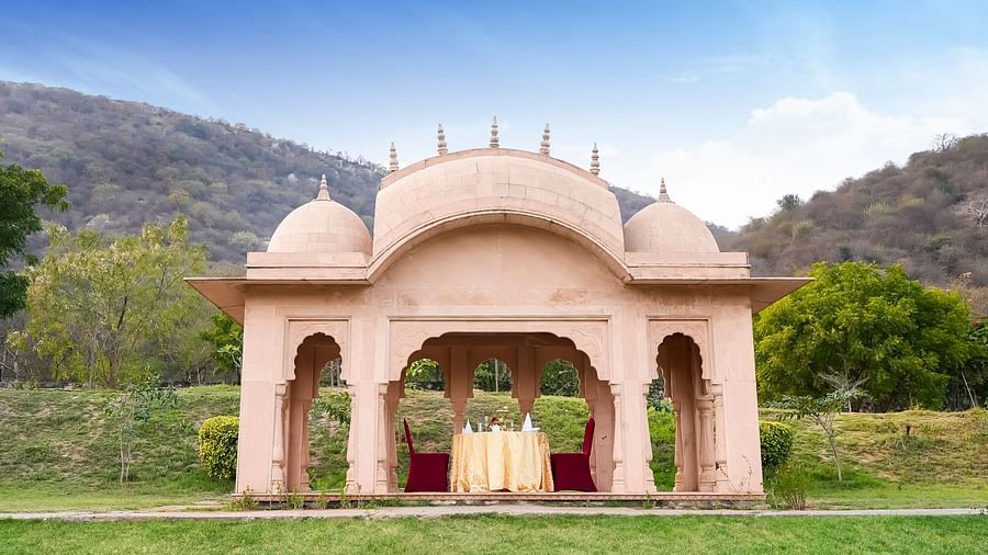 A structure in the middle of a lawn with a table in between - Rajasthali Resort & Spa, Jaipur.