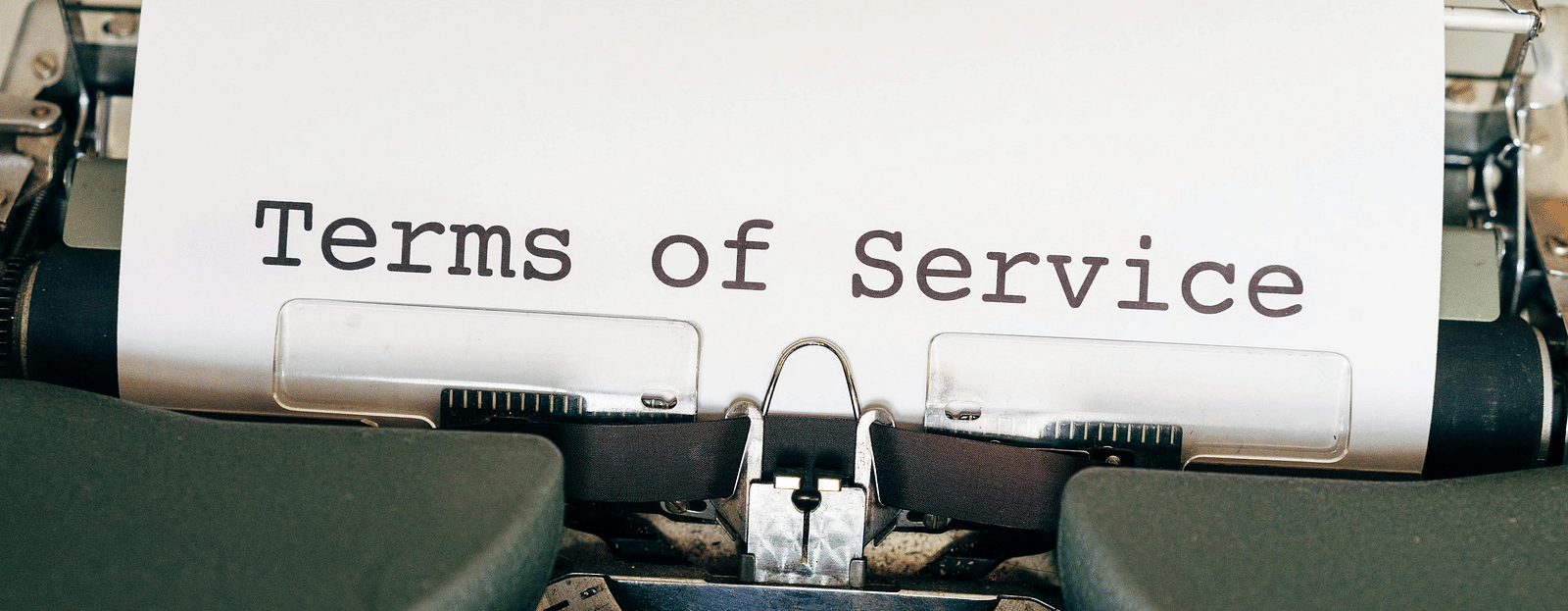 Typewriter with a piece of paper labeled Terms of Service.