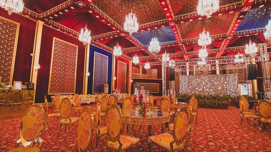 Image of a banquet hall with chairs and chandeliers hanging from the ceiling at Rajasthali Resort & Spa Jaipur.