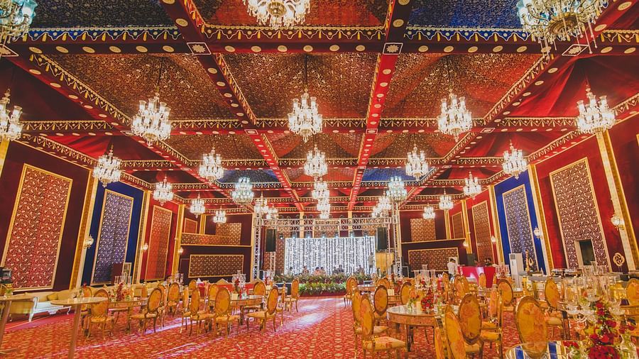 Image of Swarn Mahal with chairs and tables and chandeliers hanging from the ceiling at Rajasthali Resort & Spa Jaipur.