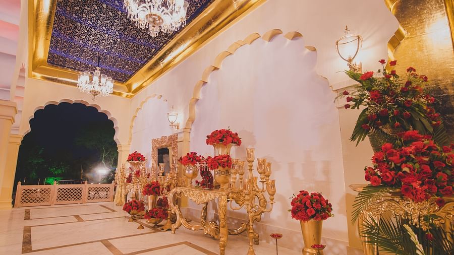Image of Swarn Mahal with large  vases filled with flowers at Rajasthali Resort & Spa Jaipur.