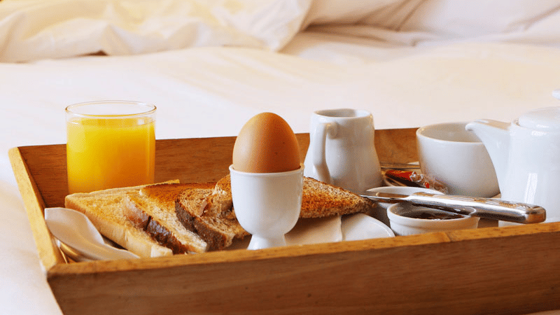 a tray with breakfast served on bed
