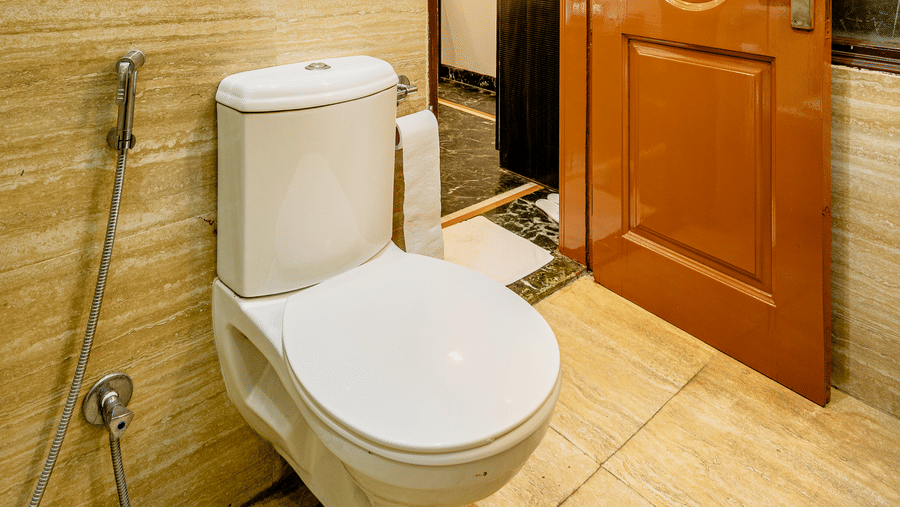 Modern hotel bathroom entrance with contemporary fittings and tiled interiors.