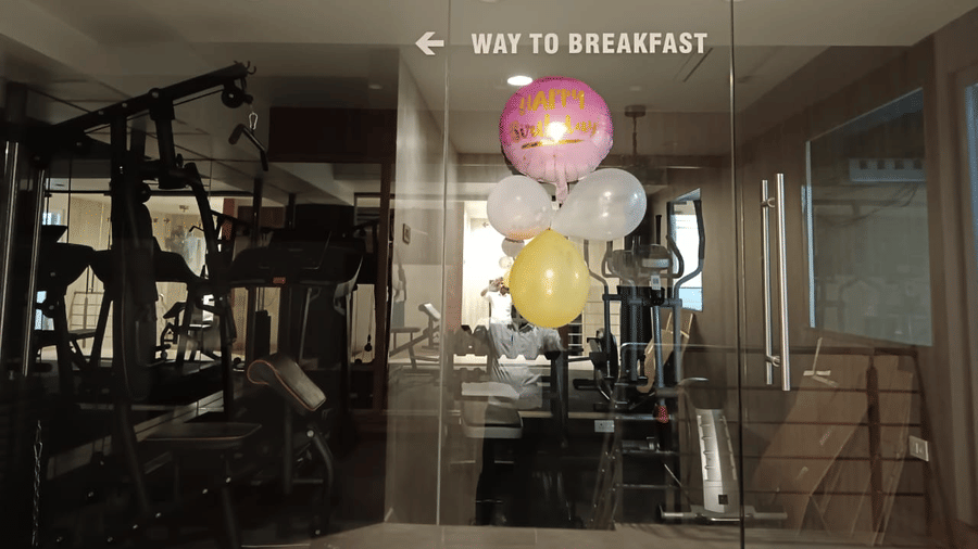The gym at the SRS Suites, Koramanagala, featuring several balloons attached to the glass door.