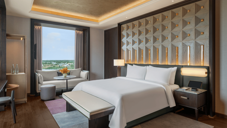 Presidential Suite Room 8001 Bedroom 2 with a bed and window garden view at The Residency Signature Madurai.