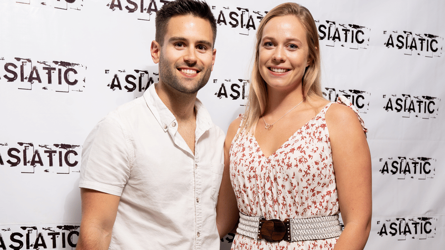 A man and a woman posing for an event at Asiatic Rooftop Bar and Restaurant