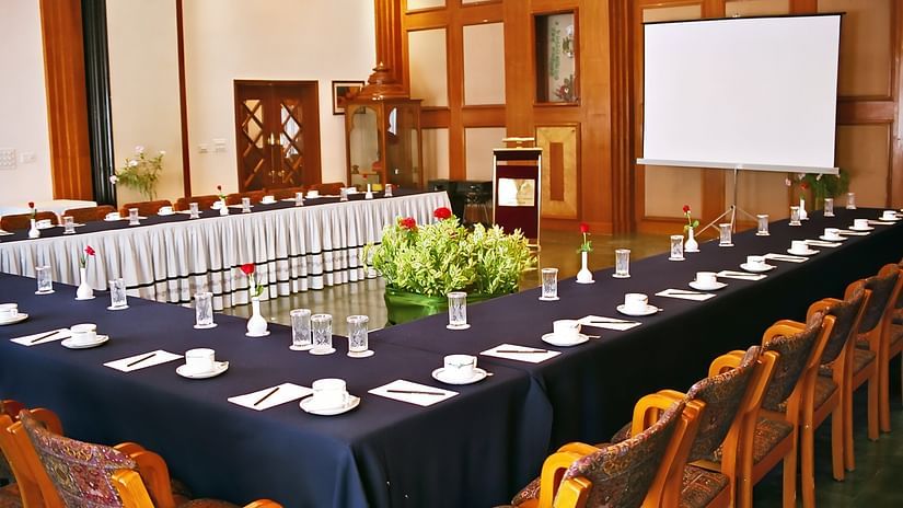 A board room with table and chair and screen for presentation at the Ummed Ahmedabad 
