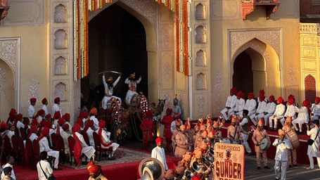 Cultural event at a historic fort in Jaipur, showcasing Indian tradition with people in vibrant attire.