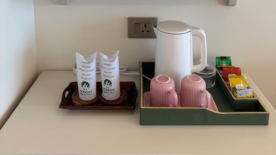 Refreshment counter with tea and coffee amenities and fresh flowers - Mayfair Cafe & Suites, Dalhousie