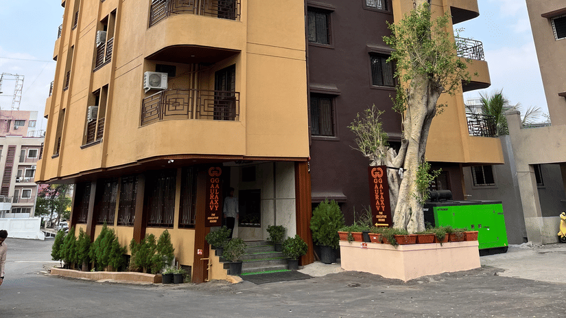 Facade of VITS Select Kharadi, Pune, our hotel near Pune Airport, with curved balconies stands beside tall trees