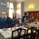 Hotel Devnadi, Haridwar | A dining space with chairs, tables, and a fan.