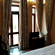 A room with a large bed, spreads, pillows, and windows. | Hotel Devnadi, Haridwar