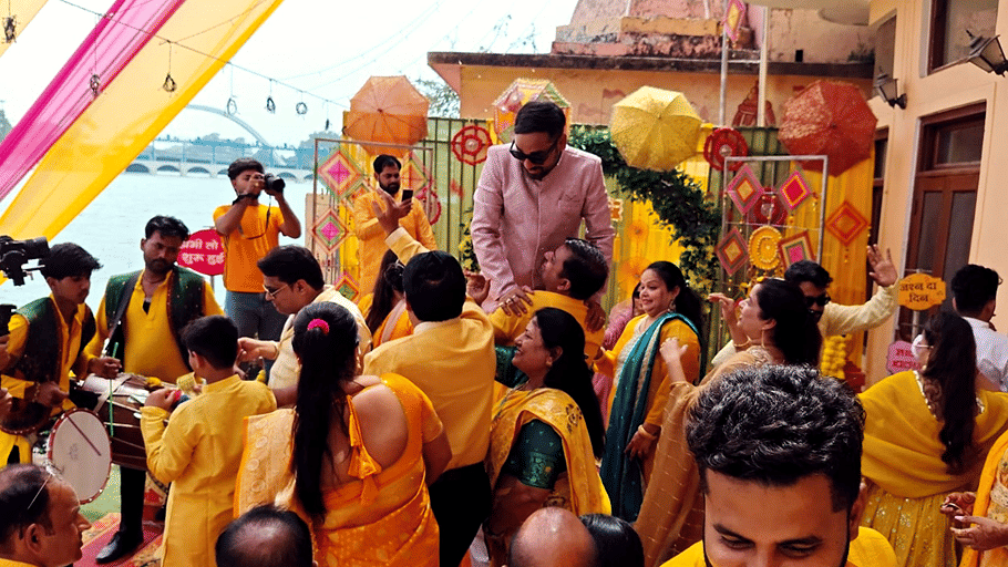 An event space with several people performing rituals. | Hotel Devnadi, Haridwar