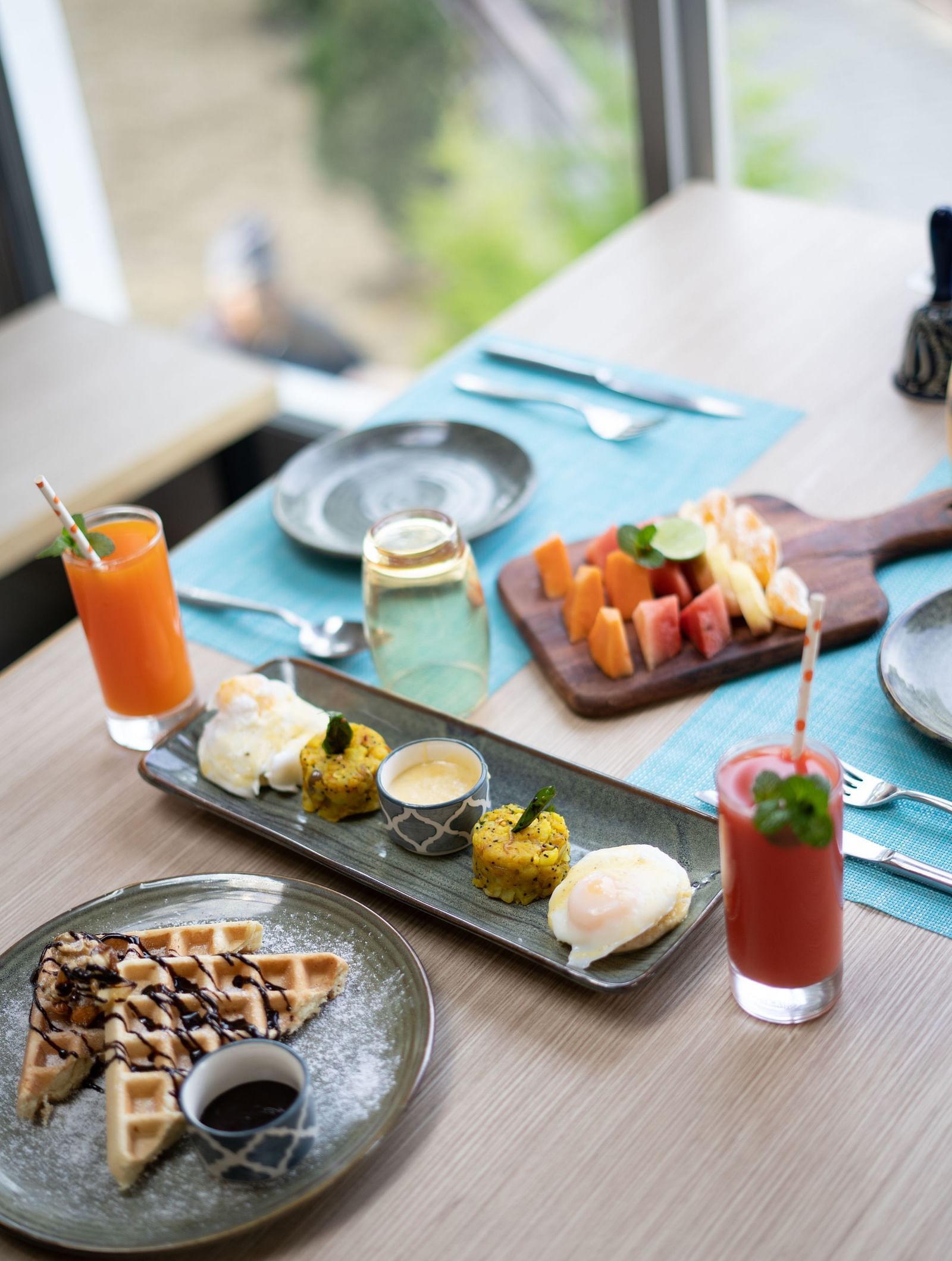 Waffles, fruit slices, and assorted desserts displayed on a plate at BluSalzz Escapade Resort, Lansdowne.