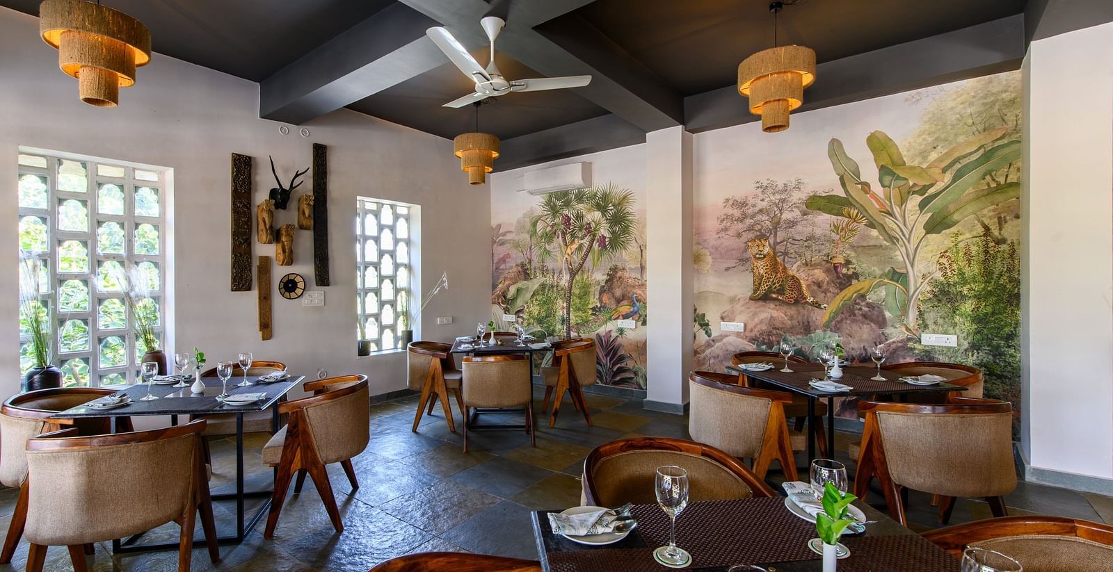 An image of a restaurant with with seating arrangement and buffet with minimal decoration - Utsav Camp Sariska