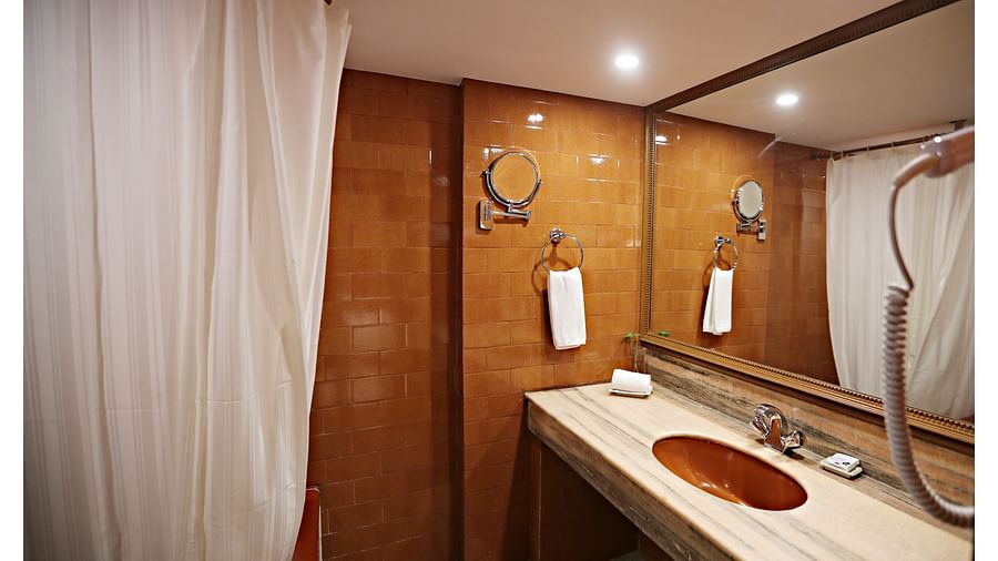 the bathtub and wash basin area at the washroom of Deluxe suites in Visakhapatnam