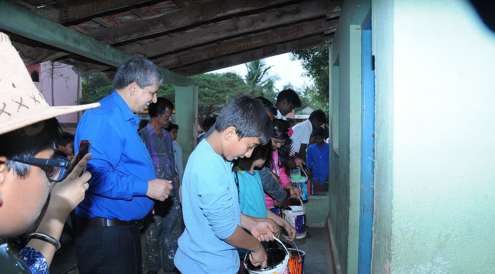 image of a boy painting the walls of the school