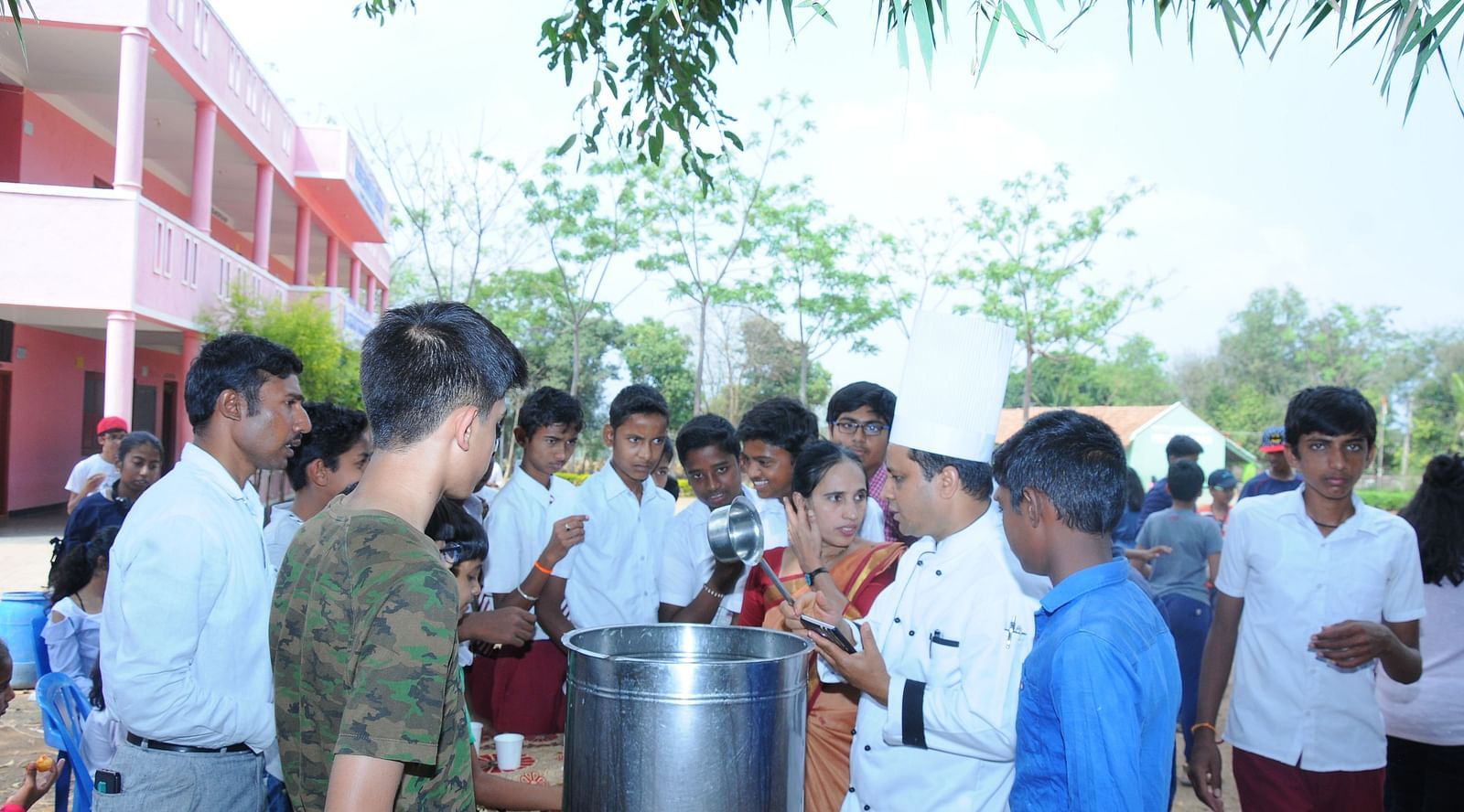 image of the head chef serving beverage to the people 