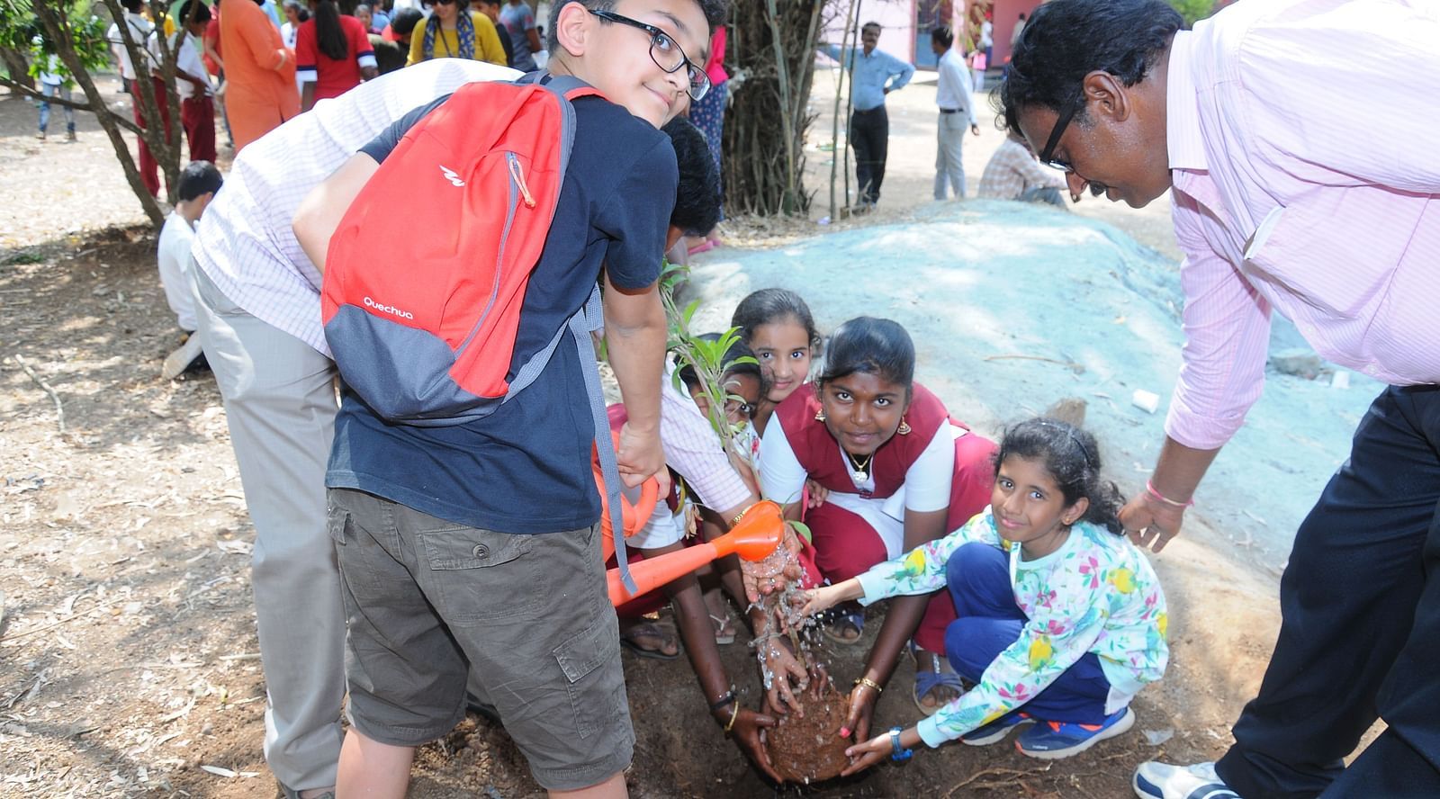 image of a group of children planting saplings at a government school in hassan