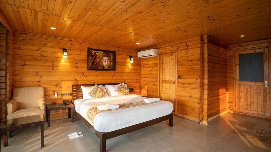 The wooden interiors and plush bed inside the Family Suite - Stone Wood Riverfront Resort, Siolim