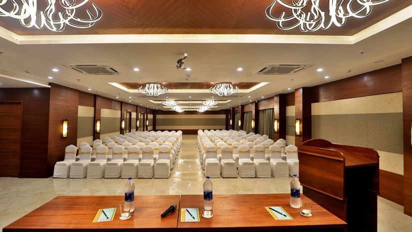 Theatre style seating arrangements with a desk on the podium inside the Banquet hall - VITS Devbhumi, Dwarka