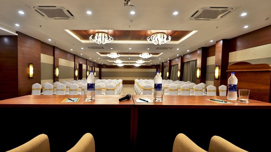 Theatre style seating arrangements with a desk on the podium inside the Banquet hall - VITS Devbhumi, Dwarka